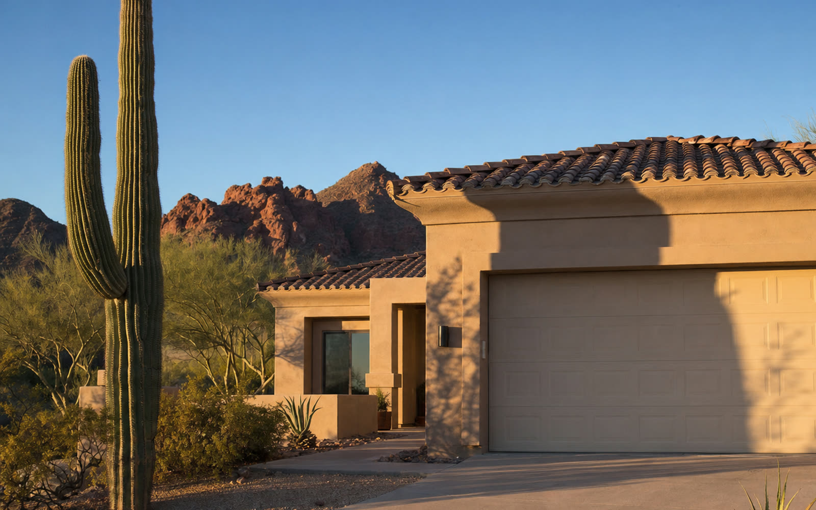 Warm desert morning light on a Phoenix home with a sand-toned garage door